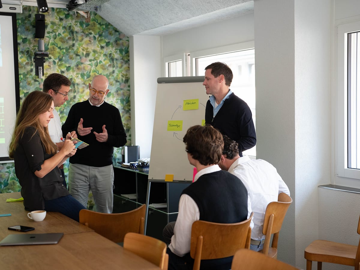elaboratum Mitarbeitende bei einem Workshop am Flipchart